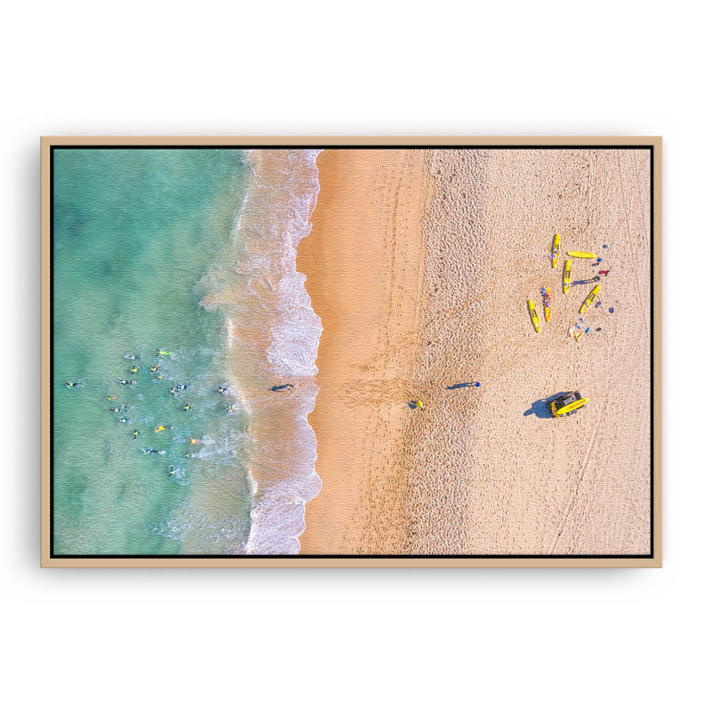 Aerial view of swimmers at Trigg Beach in Perth, Western Australia framed canvas in raw oak