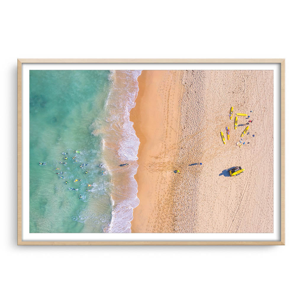 Aerial view of swimmers at Trigg Beach in Perth, Western Australia framed in raw oak